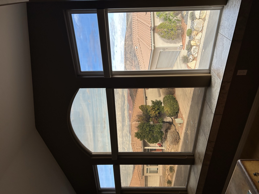 Arched picture windows framing a red-rock desert view